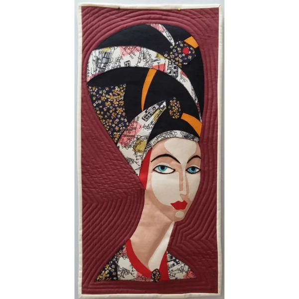 Afrocentric art quilt "Lady in Headress" celebrates African culture with a vibrant portrait of a woman adorned in traditional attire