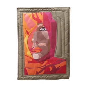 A vibrant art quilt portraying a woman's serene face, veiled in a colorful headscarf, evoking a sense of Middle Eastern culture