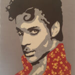 An Art Quilt of a male singer with curly black hair and a flowered shirt.