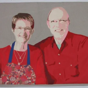 The image is of a fabric Art Quilt depicting a woman and a man dressed in red, sitting side by side.